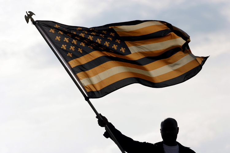 30 May 2010. New Orleans, Louisiana, USA.  
Lower 9th Ward. Flag waving on the levee wall on the set of Spike Lee's latest movie for HBO. 'If God is Willing and the Creek Don't Rise.'
Photo; Charlie Varley. (Charlie Varley)