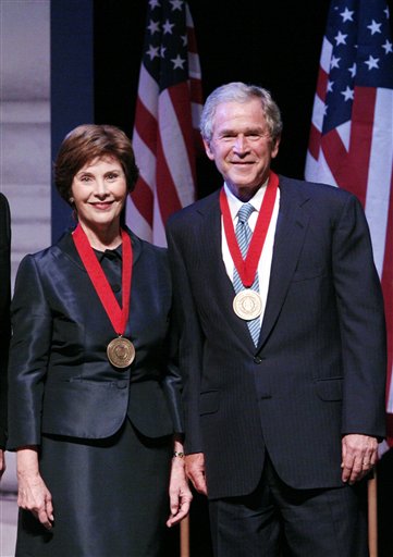 Former President George W. Bush and former First Lady Laura W. Bush pose for photographs after receiving the Southern Methodist University John Goodwin Tower Center Medal of Freedom Wednesday, April 21, 2010 in Dallas. (AP Photo/Amy Gutierrez) (AP)