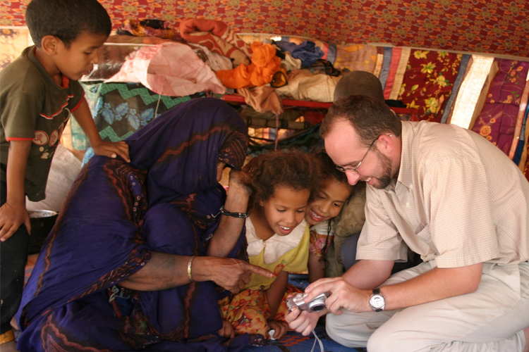 Bedouins in their tent near the village of Maatamoulana, Mauritania, seeing their digitized faces for the first time.