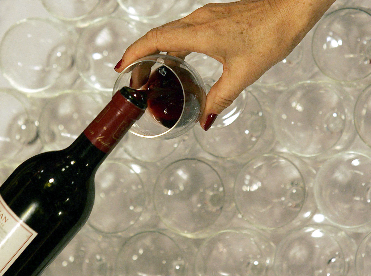 A woman tastes red wine in the Millesima cellar in Bordeaux, southwestern France, November 6, 2007.  REUTERS/Regis Duvignau (FRANCE) (Â© Regis Duvignau / Reuters)