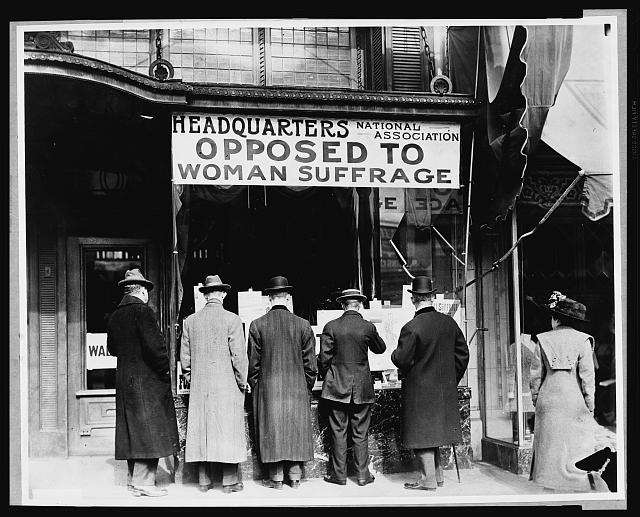 Men looking in the window of the National Anti-Suffrage Association headquarters circa 1911.