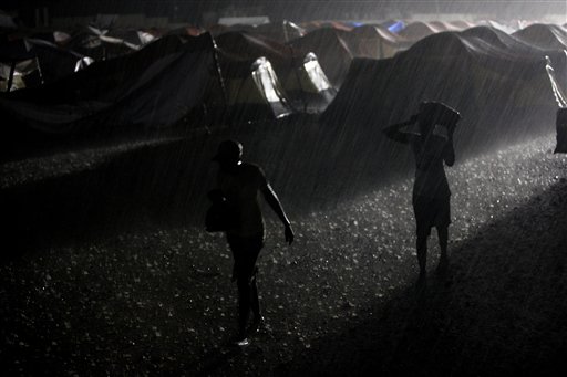 Women walk under heavy rain at a camp for earthquake displaced people in Port-au-Prince, Friday, May 21, 2010.(AP Photo/Esteban Felix) (AP)