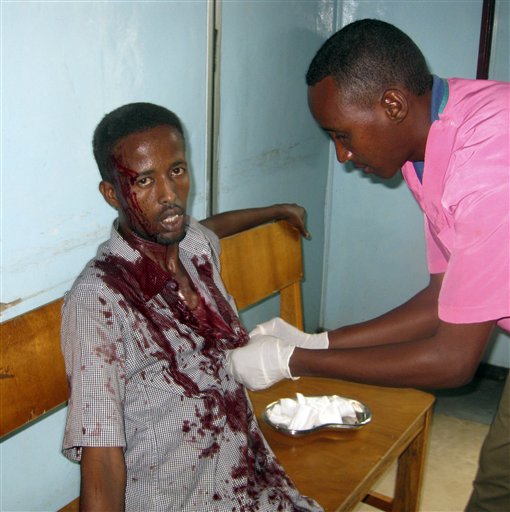 A nurse at Medina hospital treats a wounded civilian,at Medina hospital, Mogadishu, Somalia, Tuesday, Aug. 24, 2010. after he was wounded by mortar shrapnel during fighting between Somali insurgents and African Union troops. A suicide bomber and gunmen stormed a hotel in Somalia's capital on Tuesday, killing at least 15 people including members of parliament in an attack that set off an hour-long gun battle, a military spokesman and a witness said. (AP Photo/ Mohamed Sheikh Nor) (AP)