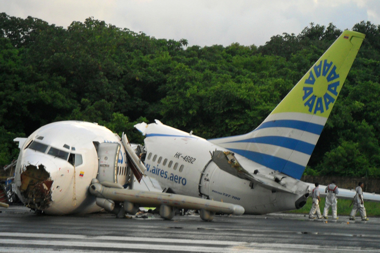 Navy officers walk near the wreckage of a Colombian passenger plane that crashed in the Caribbean resort island of San Andres on Monday.