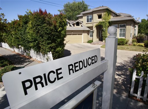 A home for sale is posted at a reduced price in Palo Alto, Calif., Thursday, June 24, 2010. Mortgage rates fell this week to the lowest level on record, giving consumers added incentive to lock in low payments for home purchases and refinanced loans. (AP Photo/Paul Sakuma) (AP)