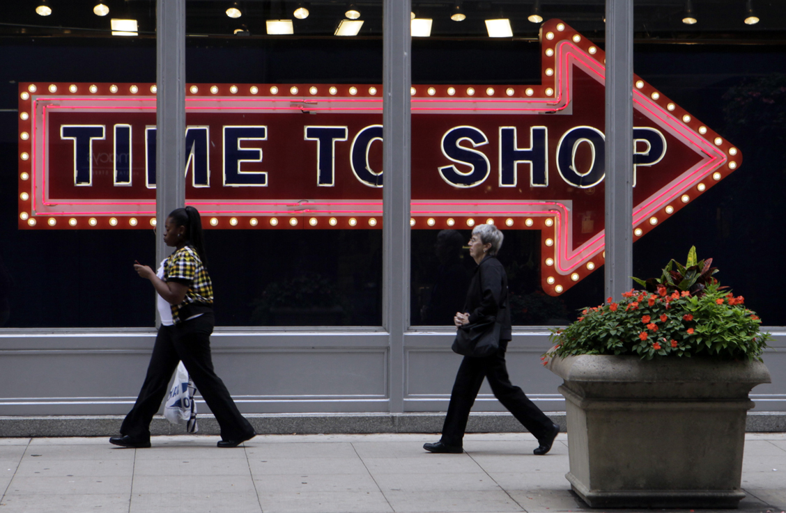 Pedestrians walk by the window display at an Old Navy store in Monday, Sept. 21, 2009 in downtown Chicago. (AP Photo/Kiichiro Sato) (Kiichiro Sato)