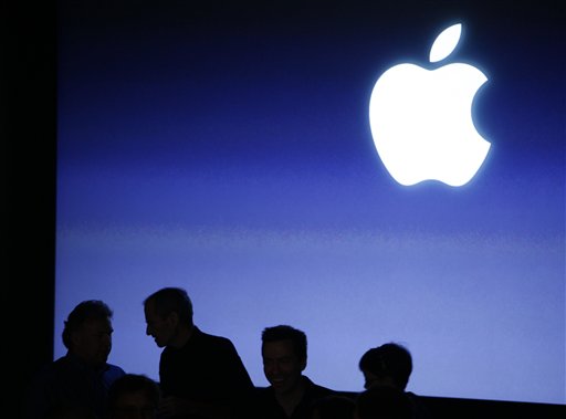 FILE - In this file photograph taken April 8, 2010, Apple Inc. Chairman and CEO Steve Jobs, second left, talks with senior vice president of worldwide marketing Philip Schiller, left, following an event at Apple Inc. in Cupertino, Calif. Apple Inc. reports second-quarter earnings Tuesday, July 20, 2010, after the market close. (AP Photo/Eric Risberg, file) (AP)