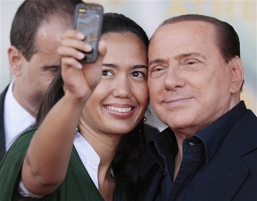 Italian Premier Silvio Berlusconi has a picture taken with a supporter at the end of his address at the People of Freedom party meeting in Rome, Sunday, Sept. 12, 2010. Berlusconi will speak to parliament at the end of the month in a highly anticipated address that could determine the fate of his government. The speech will be Berlusconi's first major parliament appearance since he split with longtime ally Gianfranco Fini. The split potentially deprived Berlusconi of his once-solid parliamentary majority, leaving the fate of his government uncertain. (AP Photo/Gregorio Borgia) (AP)