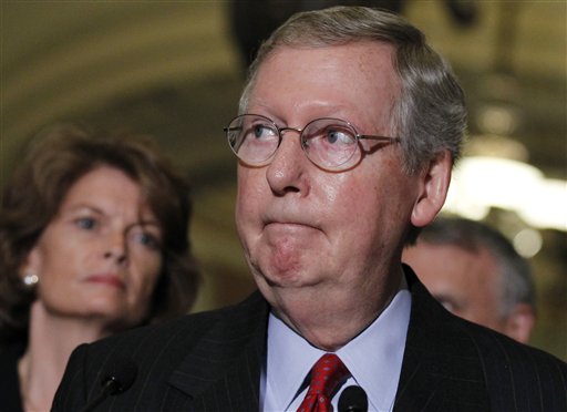 Senate Republican Leader Sen. Mitch McConnell of Kentucky, speaks to reporters just before the Democratic majority voted 60-40 to end a GOP filibuster of legislation that would extend unemployment benefits for an estimated 2.5 million Americans, at the Capitol in Washington, Tuesday, July 20, 2010. Sen. Carte Goodwin, D-W.Va., newly-sworn as the appointed successor to West Virginia's Robert Byrd who died in June, provided the crucial 60th vote for Senate Democrats. Sen. Lisa Murkowski, R-Alaska, listens at left. (AP Photo/J. Scott Applewhite) (AP)