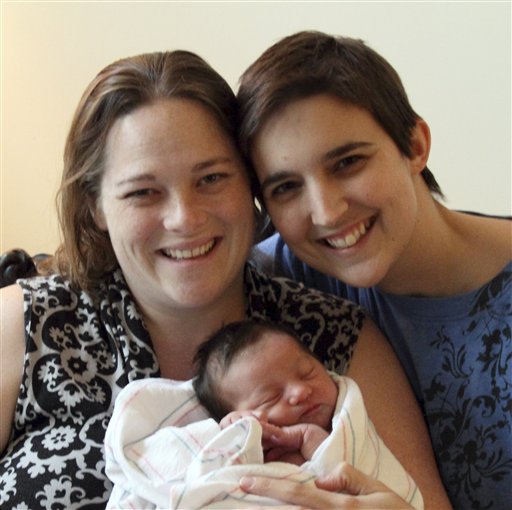 This undated photo provided by Heather Kraft shows, from left to right, Heather, baby Esther Kraft and Kathryn Kraft of Newton, Mass. Heather and Kathryn had a church wedding five years ago in white gowns and 10 bridesmaids after obtaining a marriage license under their state's gay marriage law.  The couple chose to use Kathryn's Kraft as their last name and Heather's Cole as the middle name for the entire family.  (AP Photo/Heather Kraft)   NO SALES (AP)