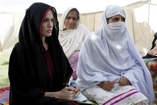 In this photo provided by the United Nations High Commission for Refugees, Angelina Jolie, left, the goodwill ambassador of UNHCR, sits with Pakistani flood-affected women during her visit to a camp for people displaced by heavy floods in Nowshera, Pakistan, Tuesday, Sept. 7, 2010. (AP Photo/United Nations High Commission for Refugees, J. Tanner) ** NO SALES, NO ARCHIVE, EDITORIAL USE ONLY ** (AP)