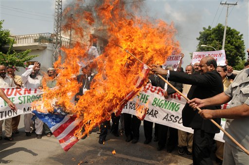 Pakistani lawyers burn a U.S. flag while rallying in reaction to a small American church's plan to burn copies of the Quran in Multan, Pakistan on Thursday, Sept. 9, 2010. (AP Photo/Khalid Tanveer) (AP)