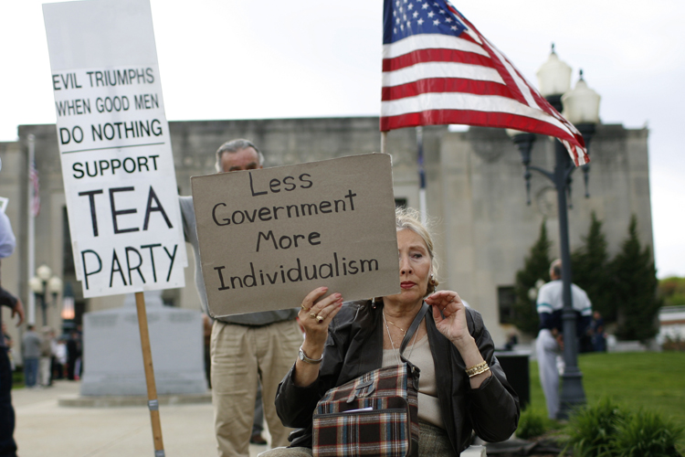 A woman holds a sign at a tax day rally by Tea Party activists in the New York City suburb of New City, New York, April 15, 2010. April 15 is the deadline for filing tax returns in the U.S.  REUTERS/Mike Segar  (UNITED STATES - Tags: BUSINESS POLITICS) (Â© Mike Segar / Reuters)