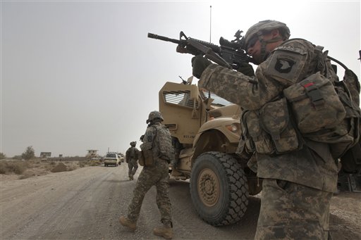 FILE - In this Aug. 26, 2010 file photo, U.S. Army Spc. Cody Borawa, of Unadilla, N.Y., of Tactical Command Post, HQ Company, 2-502 Infantry, 101st Airborne Division, looks for a Taliban position, during a day of joint missions with the Afghan Army, in Zhari district, Kandahar province, southern Afghanistan. Since May, troops from the U.S. Army's 101st Airborne Division have flooded into this region in a bid to disrupt the guerrillas' operations and block them from staging attacks into Kandahar city, the security of which is considered a linchpin of American strategy to win the conflict. But the militants, some from neighboring Pakistan, have brought in hundreds of fighters of their own and stepped up attacks, U.S. officers say. (AP Photo/Brennan Linsley, File) (AP)