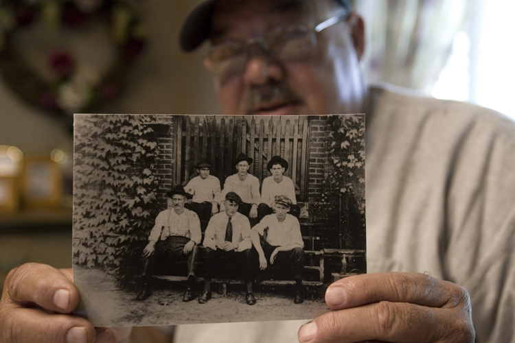 James D. Cannon holds a family photo that shows his grandfather, Claude Cannon, seated in the front row far left, who was killed in the Chiquola Mill shooting in 1934 were 7 people died and over 34 people injured over labor unions that the mill didn't want.(AP Photo/Mary Ann Chastain) (Mary Ann Chastain)