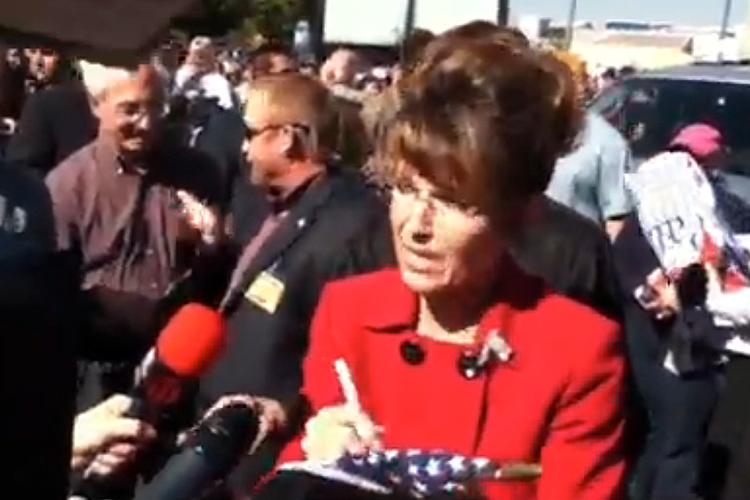 While campaigning in Reno this week, Sarah Palin puts her signature to...something