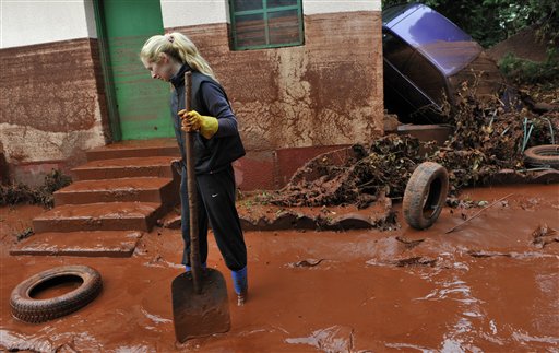 Tunde Erdelyi is seen in her yard flooded by toxic mud in the town of Devecser, Hungary, Tuesday, Oct. 5, 2010. Monday's flooding was caused by the rupture of a red sludge reservoir at an alumina plant in western Hungary and has affected seven towns near the Ajkai Timfoldgyar plant in the town of Ajka, 100 miles (160 kilometers) southwest of Budapest. (AP Photo/Bela Szandelszky) (AP)