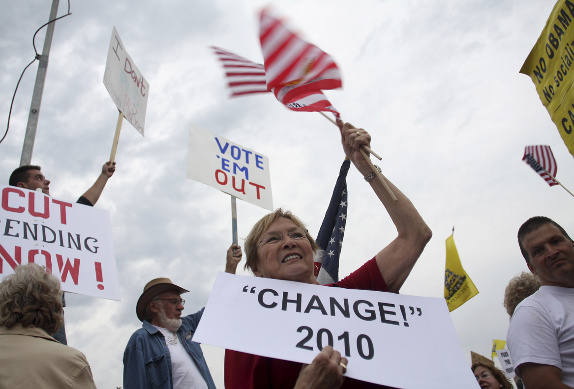 People hold signs during a "tea party" protest in Flagstaff, Arizona August 31, 2009. Organizers say the event is an effort to work against members of Congress who voted for higher spending and taxes. REUTERS/Joshua Lott (UNITED STATES BUSINESS CONFLICT POLITICS) (Â© Joshua Lott / Reuters)
