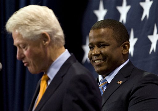 FILE - In this Oct. 19, 2010 file photo, Florida Democratic senate candidate Kendrick Meek, right, smiles as he listens to former President Bill Clinton address supporters during a campaign rally in St. Petersburg, Fla. Meek is denying reports that he agreed to drop out of the Florida Senate race under pressure from former President Clinton. Politico on Thursday, Oct. 28, 2010 reported that Clinton attempted to persuade Meek last week while campaigning with him in Florida. (AP Photo/Steve Nesius, File) (AP)