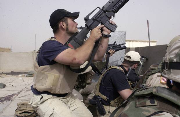Plainclothes contractors working for Blackwater USA take part in a firefight on Sunday, April 4, 2004 in the Iraqi city of Najaf