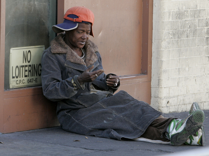 A homeless person sits on the sidewalk on skid row in downtown Angeles, California November 25, 2009. REUTERS/Fred Prouser    (UNITED STATES SOCIETY) (Â© Fred Prouser / Reuters)