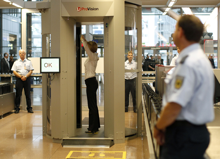 A security official demonstrates a full body scanner during a photocall at Departure Gate 2 at Hamburg Airport September 27, 2010. Germany started on Monday the voluntary use of two 'L-3  Provision ATD' body scanners for a test period over the next six months at the airport.   REUTERS/Christian Charisius (GERMANY - Tags: TRANSPORT SCI TECH) (Â© Christian Charisius / Reuters)