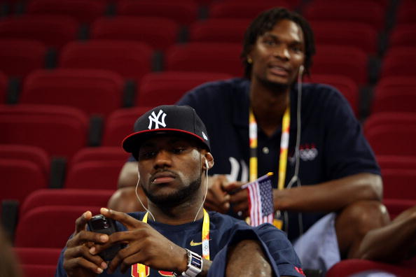 BEIJING - AUGUST 09:  (F-B) LeBron James and Chris Bosh of the United States men's basketball team sit in the stands for the US women's team game against the Czech Republic during the women's preliminary basketball game at the Beijing Olympic Basketball Gymnasium during day 1 of the Beijing 2008 Olympic Games on August 9, 2008 in Beijing, China.  (Photo by Mark Dadswell/Getty Images) (Getty Images)