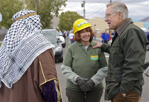 Nevada Sen. Harry Reid, D-Nev., talks with Leslie and James Medeiros, who are in costume to protest our dependence on foreign oil, during the Nevada Day Parade in Carson City, Nev., Saturday, Oct. 30, 2010. (AP Photo/Scott Sady) (AP)
