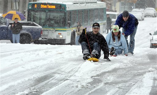 From left, William Gordon, Jessica Fuller and Howie West, make use of alternate forms of transportation after South Ninth Street became unsafe for many vehicles in downtown Tacoma, Wash., Monday, Nov. 22, 2010.  A few minutes earlier the Pierce Transit bus, background, slid into a pickup truck. People in most of Eastern Washington were told Monday to prepare for a rare blizzard as the first severe storm of the winter blasted through the state, though weather officials said it was too early to tell if the rough weather would affect Thanksgiving holiday travel later in the week. (AP Photo/The News Tribune, Janet Jensen) (AP)