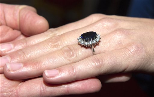 Prince William holds her hand as Kate Middleton wears her engagement ring which once belonged to Diana, Princess of Wales, on the day their engagement was announced in London Tuesday Nov.16, 2010. Prince William revealed that he proposed using the engagement ring of his mother, Diana, Princess of Wales, to make sure Diana "didn't miss out on the excitement". William and his long-term girlfriend got engaged on holiday in Kenya last month and will marry next year. (AP Photo/Arthur Edwards, pool) (AP)