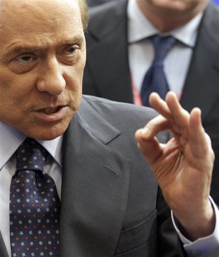 Italy's Prime Minister Silvio Berlusconi gestures while speaking during a media conference at an EU summit in Brussels on Friday, Oct. 29, 2010. EU leaders on Friday agreed on tougher rules for spendthrift nations whose overspending threatens Europe's single currency and risks triggering a debt crisis. (AP Photo/Yves Logghe) (AP)