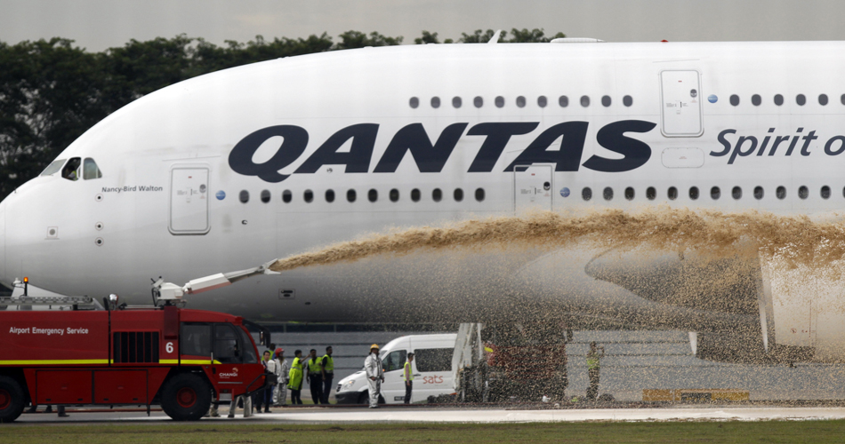 Qantas Airways 380 passenger plane flight QF32 is sprayed by rescue services after making an emergency landing at Changi airport in Singapore November 4, 2010. The Airbus A380, which had originated in London and was carrying 459 people, suffered failure of one of its four engines shortly after it had left the island state en route for Sydney. Australian officials said no one on board was injured.    REUTERS/Vivek Prakash   (SINGAPORE - Tags: TRANSPORT DISASTER BUSINESS IMAGES OF THE DAY) (Â© Vivek Prakash / Reuters)