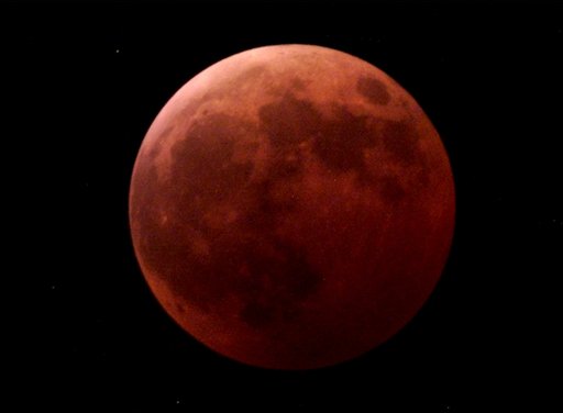 FILE - The moon appears totally covered by shadow as the earth passes between the moon and the sun, during the lunar eclipse in this Jan. 9, 2001 file photo taken in Kiel, Germany. On Tuesday Dec. 21, 2010 the first day of northern winter, the full Moon passes almost dead-center through Earth's shadow. The eclipse begins at 1:33 am EST. At that time, Earth's shadow will appear as a dark-red bite at the edge of the lunar disk. It takes about an hour for the "bite" to expand and swallow the entire Moon. Totality commences at 2:41 am EST and lasts for 72 minutes. According to NASA the last total lunar eclipse that happened on the winter solstice was Dec. 21, 1638. The next one will Dec. 21, 2094. (AP Photo/Heribert Proepper, File) (AP)