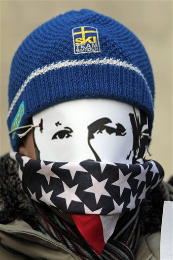 A supporters of WikiLeaks founder Julian Assange, wearing a mask depicting him and a US flag on his mouth, partiipates at  demonstrate outside theS wedish Embassy In central London, Monday, Dec. 13, 2010 Assange remains in a U.K. jail ahead of a Dec. 14 hearing where he plans to fight Sweden's request to extradite him to face sex crimes allegations there. (AP Photo/Lefteris Pitarakis) (AP)