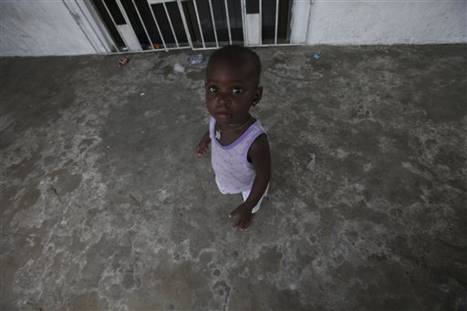 A child who fled with his mother following a deadly army attack on Ayakoromor village stands at a microcredit organization where they have take refuge with other members of the community in the nearby town of Warri, Nigeria, Saturday, Dec. 4, 2010. The military launched Wednesday a massive attack including aerial bombings that was aimed at finding a wanted militant. Civilians caught in the middle tried to escape with their lives, human rights activists say. The violence represents yet another example of how those toiling in poverty in a region that makes billions for Nigeria find themselves caught between a military seeking revenge and power-hungry militants.(AP Photo/Sunday Alamba) (AP)
