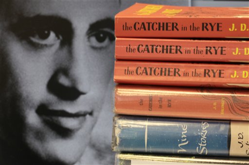 FILE - This Thursday, Jan. 28, 2010 picture shows copies of J.D. Salinger's classic novel "The Catcher in the Rye" as well as his volume of short stories called "Nine Stories" at the Orange Public Library in Orange Village, Ohio. Salinger, the legendary author, youth hero and fugitive from fame whose "The Catcher in the Rye" shocked and inspired a world he increasingly shunned, died Wednesday at the age of  91. At left is a 1951 photo of the author. (AP Photo/Amy Sancetta, File) (AP)