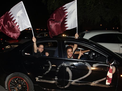 Qataris react in a car, after the announcement that Qatar will host the soccer World Cup in 2022, in Doha, Thursday, Dec. 2, 2010. (AP Photo/Osama Faisal) (AP)
