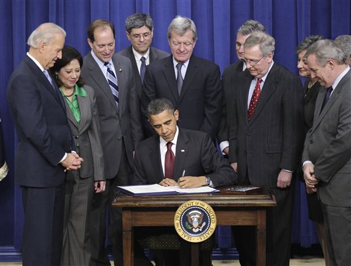FILE - In this Dec. 17, 2010 file photo, President Barack Obama, joined by Republican and Democratic lawmakers, signs the bipartisan tax package that extends tax cuts for families at all income levels, during a signing ceremony at the Eisenhower Executive Office Building on the White House complex in Washington. The massive new tax law signed by President Barack Obama is filled with all kinds of holiday stocking stuffers for businesses: tax breaks for producing TV shows, grants for putting up windmills, rum subsidies for Puerto Rico and the Virgin Islands.  (AP Photo/J. Scott Applewhite, File) (AP)