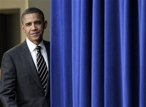 President Barack Obama pauses at the stage curtain as he arrives to sign the Claims Resolution Act of 2010 which settles long-standing lawsuits by African American farmers and Native Americans against the federal government, in the Eisenhower Executive Office Building, part of the White House complex, in Washington, Wednesday, Dec. 8, 2010. The act also authorizes $1.15 billion for black farmers who say they were discriminated against by the U.S. Department of Agriculture. (AP Photo/J. Scott Applewhite) (AP)