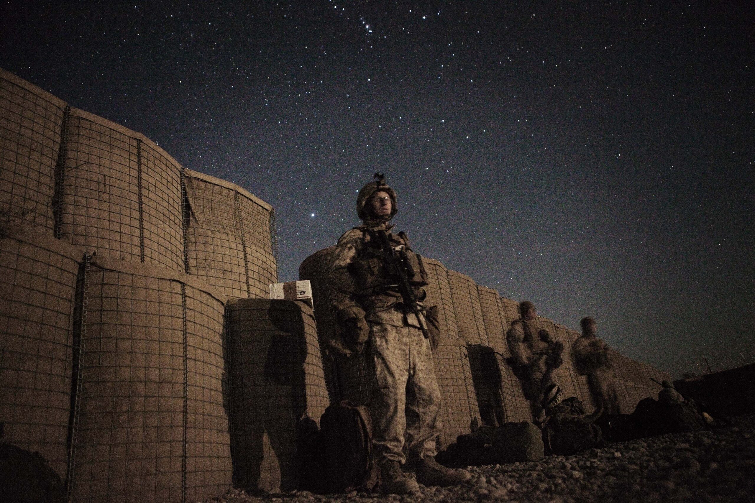 A U.S. Marine waits in the moonlight for a helicopter to transport them home for leave from Musa Qala in southern Afghanistan's Helmand province, November 16, 2010. REUTERS/Finbarr O'Reilly (AFGHANISTAN - Tags: CONFLICT CIVIL UNREST IMAGES OF THE DAY) (Reuters)