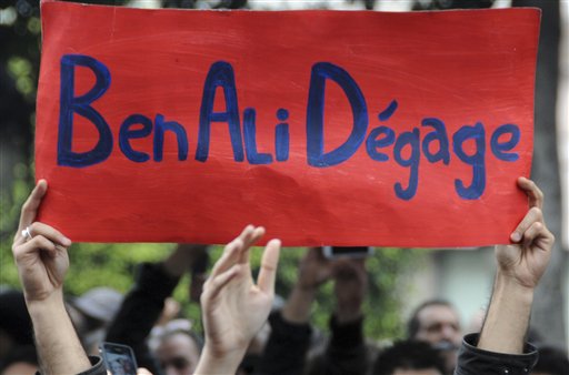 Protestors hold a banner reading "Ben Ali get out", calling for the resignation of Tunisia's President Zine El Abidine Ben Ali, in the capital, Tunis, Friday, Jan. 14,2011. Thousands of angry demonstrators marched through Tunisia's capital Friday, demanding the resignation of the country's autocratic leader a day after he appeared on TV to try to stop deadly riots that have swept the North African nation. (AP Photo) (AP)