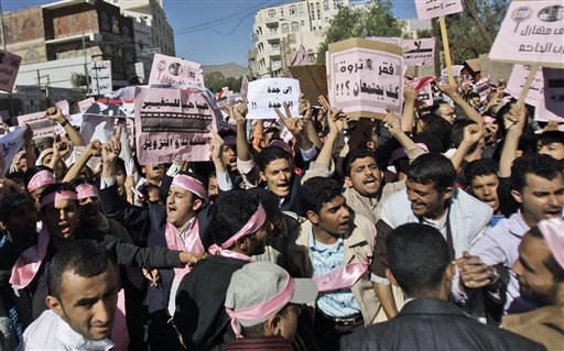 Yemeni demonstrators chant slogans during a rally  calling for an end to the government of President Ali Abdullah Saleh, in Sanaa, Yemen, Thursday, Jan. 27, 2011. Tens of thousands of people are calling for the Yemeni president's ouster in protests across the capital inspired by the popular revolt in Tunisia. The demonstrations led by opposition members and youth activists are a significant expansion of the unrest sparked by the Tunisian uprising, which also inspired Egypt's largest protests in a generation. Banners read from right: 'Together lets break the ruling party'. 'Poverty and wealth how could it work?!', 'Jeddah Jeddah', and 'Yes for change no for faking and extending'. (AP Photo/Hani Mohammed) (AP)