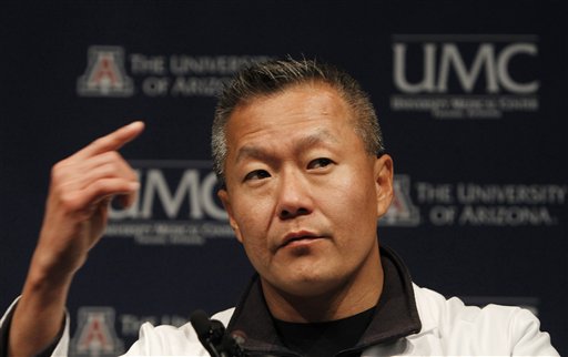FILE - In this Jan. 11, 2011 file photo, Dr. Peter Rhee, Trauma and Critical Care Emergency Surgery doctor at University Medical Center, describes in more detail the gunshot wound Rep. Gabrielle Giffords, D-Ariz.,received on Saturday, during a news briefing at UMC in Tucson, Ariz. Giffords remains in critical condition, but doctors have reported steady progress each day since she was wounded last weekend. If all goes well, she may be "out of the woods" on Friday, said Rhee. (AP Photo/Ross D. Franklin, File) (AP)