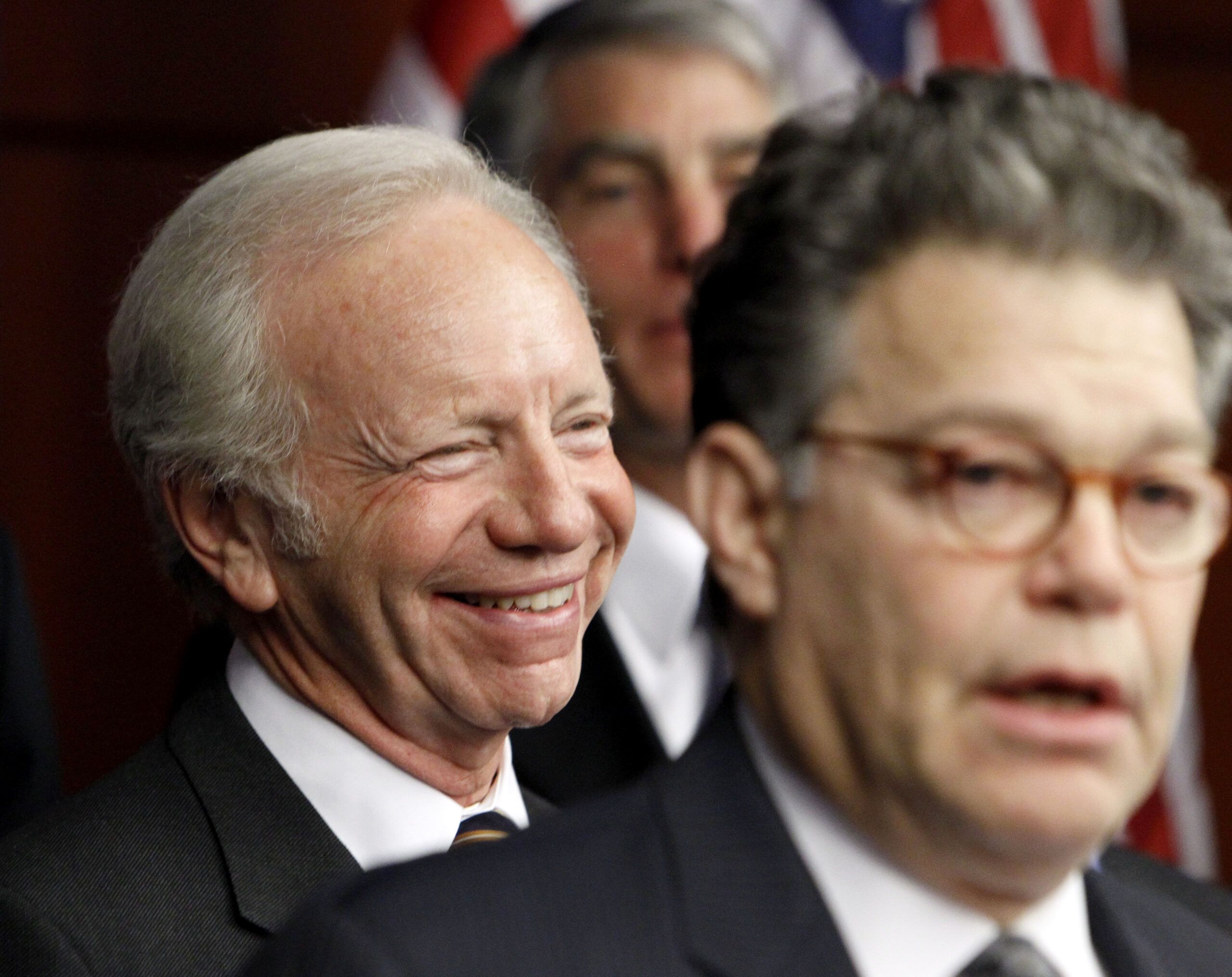 Sen. Joseph Lieberman, I-Conn., left, laughs as Sen. Al Franken, D-Minn., right, speaks during a news conference on Capitol Hill in Washington, Thursday, Nov. 18 ,2010, to push for the repeal of military Don't Ask Don't Tell rule. (AP Photo/Ann Heisenfelt) (AP)