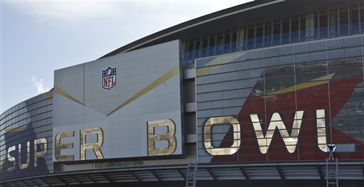 A worker puts up a logo outside Cowboys Stadium, Tuesday, Jan. 25, 2011 in Arlington, Texas, in preparation of NFL football Super Bowl XLIV. (AP Photo/Morry Gash) (AP)