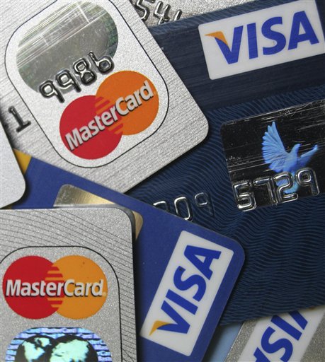 FILE - This file photo taken Nov. 18, 2009, a pile of MasterCard and VISA credit cards are displayed in Frankfurt, Germany. A sweater you buy for Christmas goes on sale for half price the next day. You might be able to get the difference back if you paid with a credit card.(AP Photo/Jochen Krause, File) (AP)