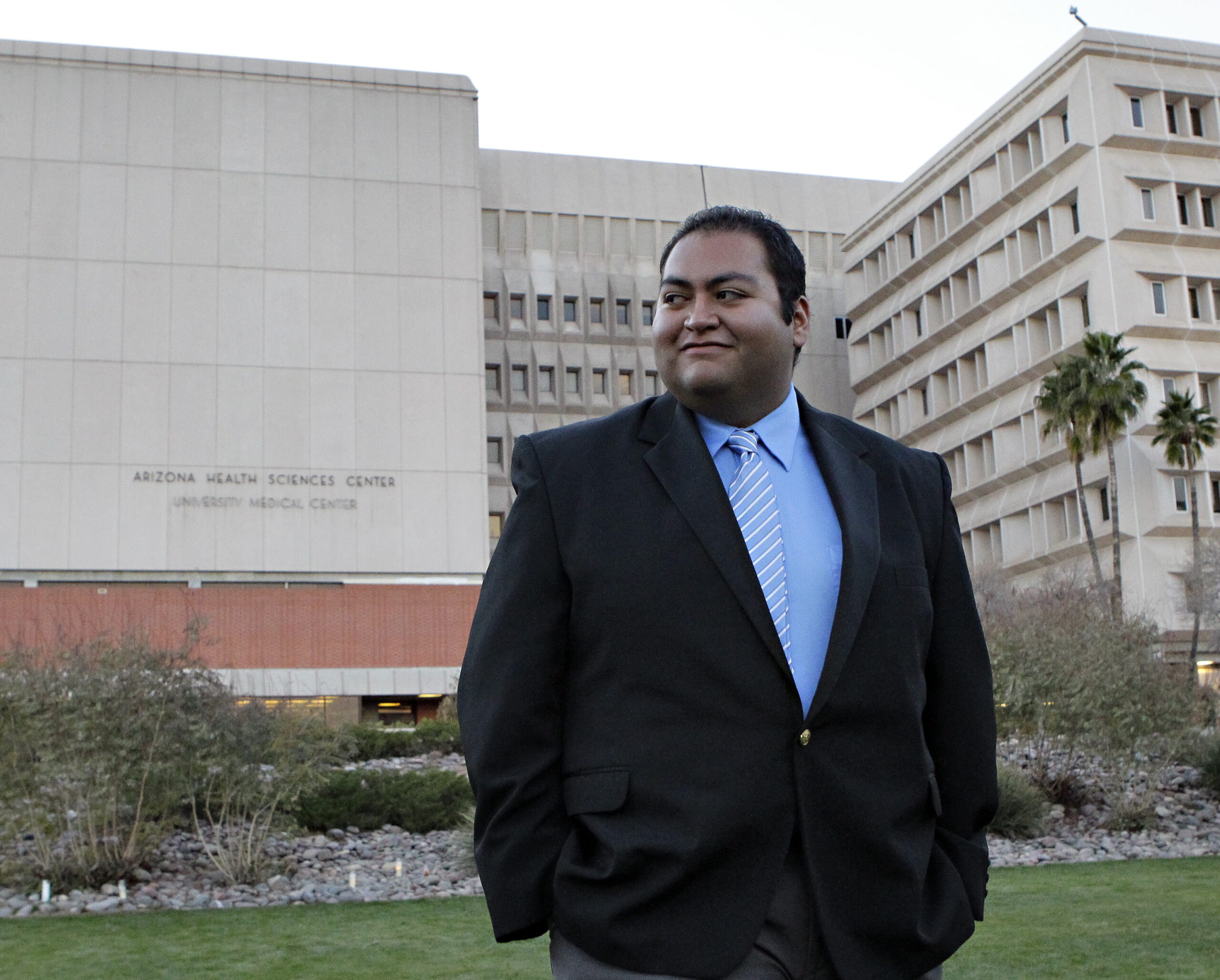 Daniel Hernandez, an intern with U.S. Rep. Gabrielle Giffords, D-Ariz., walks across the lawn outside University Hospital Sunday, Jan. 9, 2011 in Tucson, Ariz. Hernandez attended to Giffords and others immediately after Giffords was shot in the head a day earlier during a speech at a local supermarket. (AP Photo/Matt York) (AP)
