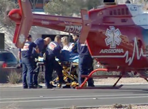 Emergency personnel use a stretcher to carry a shooting victim to a helicopter outside a shopping center in Tucson, Ariz. on Saturday, Jan. 8, 2011 where U.S. Rep. Gabrielle Giffords, D-Ariz., and others were shot as the congresswoman was meeting with constituents. (AP Photo/KGUN9-TV) MANDATORY CREDIT KGUN9-TV (AP)