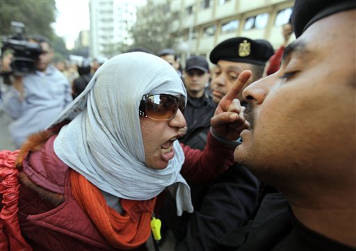Angery Egyptian activist shouts at anti-riot policemen who block the way leading to journalists syndicate in downtown Cairo, Egypt, Wednesday, Jan. 26, 2011. A small gathering of Egyptian anti-government activists tried to stage a second day of protests in Cairo Wednesday in defiance of a ban on any gatherings, but police quickly moved in and used force to disperse the group. (AP Photo/Ben Curtis) (AP)