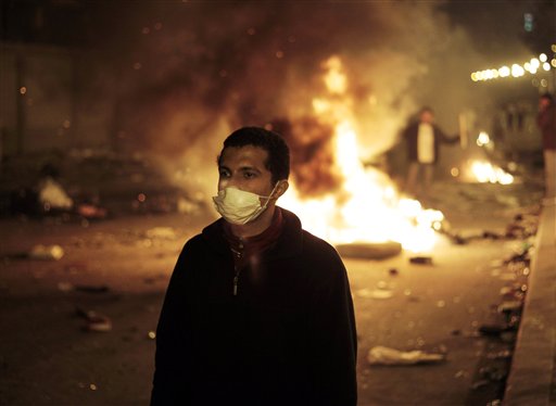 An anti-government protester is backdropped by a fire set up by protesters near the Tahrir Square, in downtown Cairo, Egypt, Friday, Jan. 28, 2011.  Egyptian activists protested for a fourth day as social networking sites called for a mass rally in the capital Cairo after Friday prayers, keeping up the momentum of the country's largest anti-government protests in years. (AP Photo/Lefteris Pitarakis) (AP)